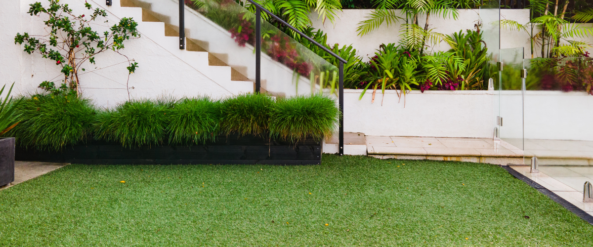 A lawn and garden in front of a home.